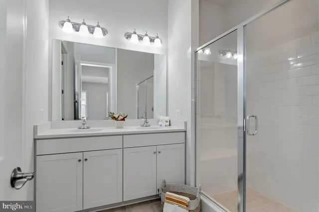 a bathroom with a double vanity sink and mirror