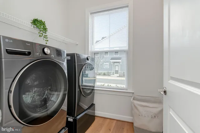 a utility room with sink dryer and washer
