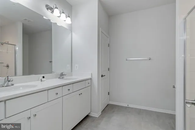 a bathroom with a double vanity sink and a mirror