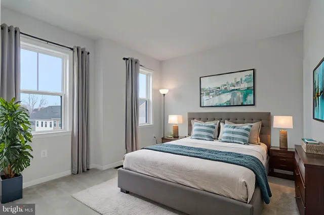 a bedroom with a large bed and potted plant