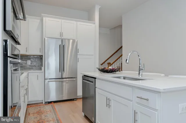 a kitchen with stainless steel appliances a refrigerator and cabinets