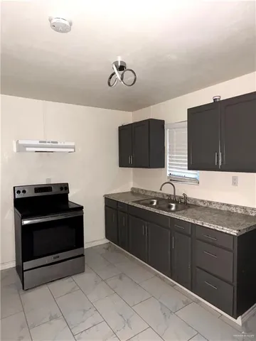 a kitchen with stainless steel appliances granite countertop a stove and a microwave