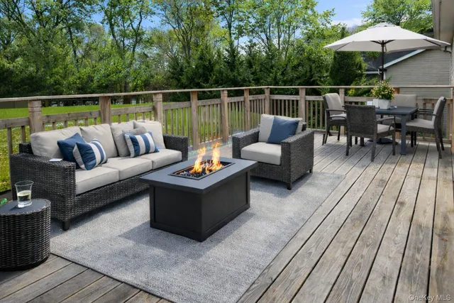 a roof deck with couches and potted plants