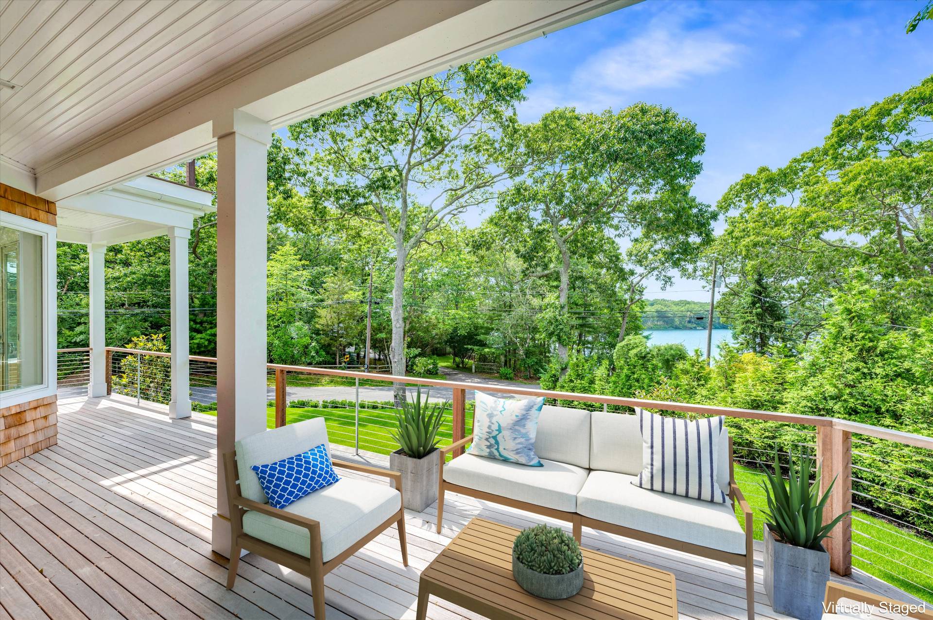 138 Big Fresh Pond Road Southampton, NY 11968 - Photo 11 of 43 a view of a chair and tables in the balcony