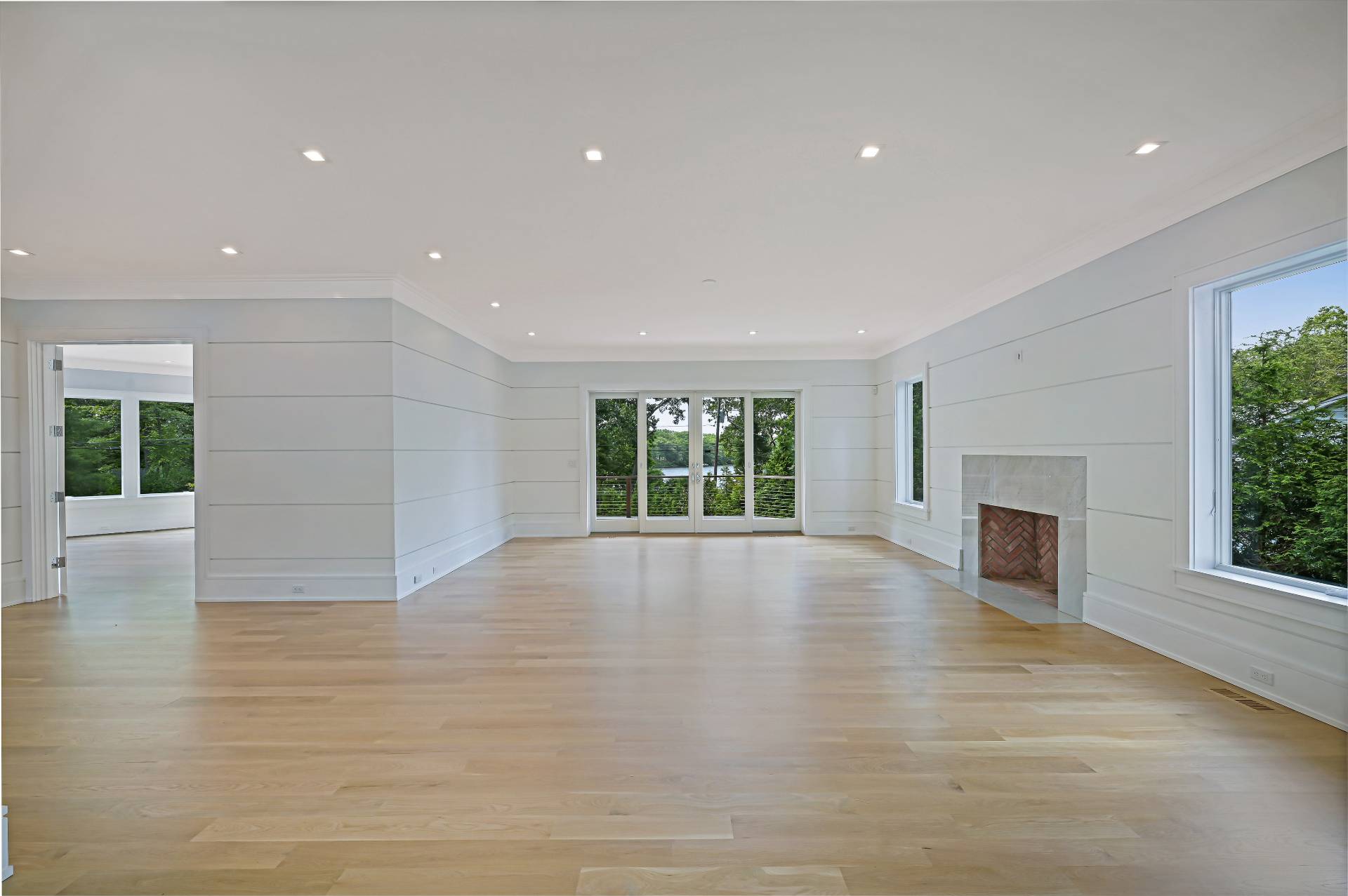 138 Big Fresh Pond Road Southampton, NY 11968 - Photo 13 of 43 a view of empty room with wooden floor and fireplace