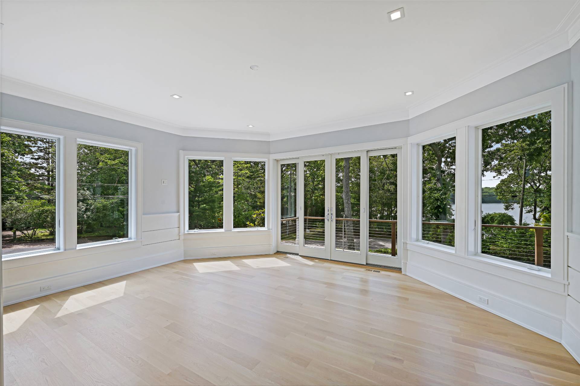 138 Big Fresh Pond Road Southampton, NY 11968 - Photo 21 of 43 a view of an empty room with wooden floor and garden