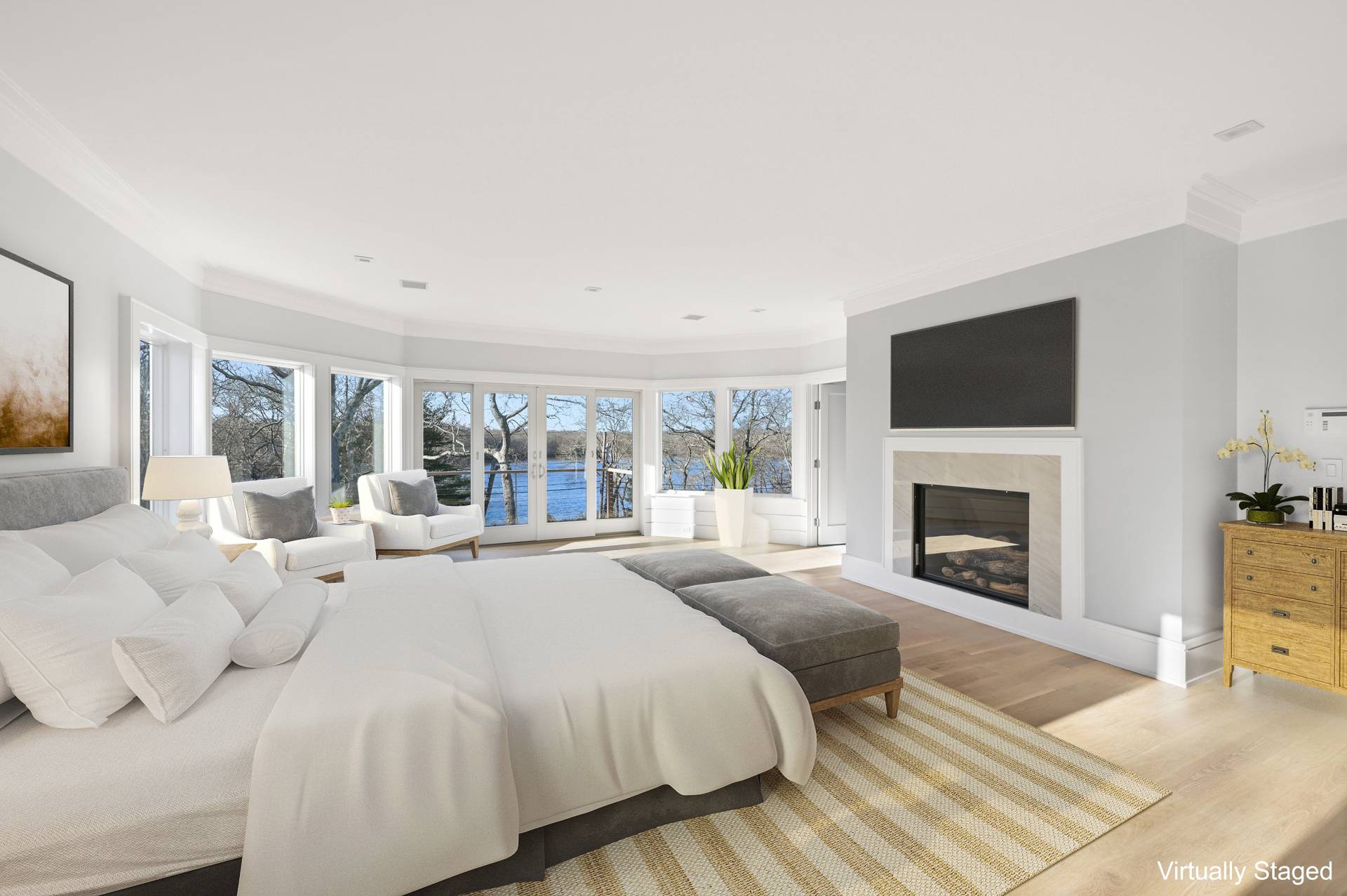 138 Big Fresh Pond Road Southampton, NY 11968 - Photo 24 of 43 a large bedroom with a large bed and a fireplace