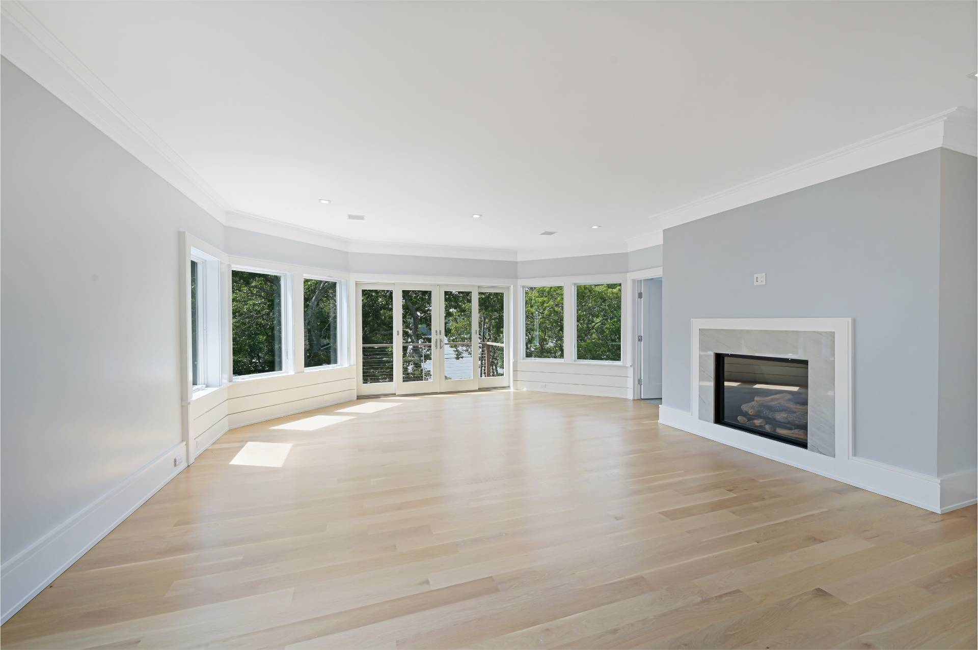138 Big Fresh Pond Road Southampton, NY 11968 - Photo 25 of 43 a view of an empty room with a fireplace and a window