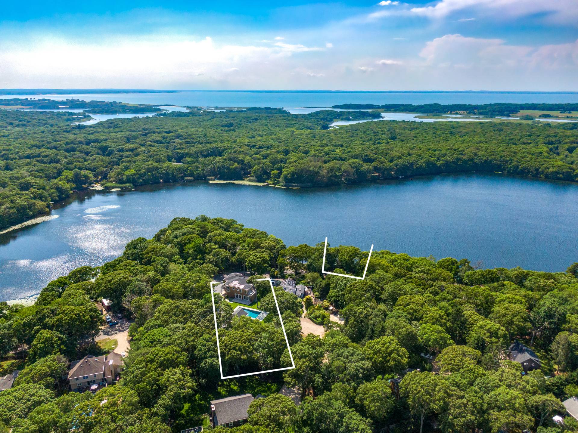 138 Big Fresh Pond Road Southampton, NY 11968 - Photo 5 of 43 a view of a lake with a city