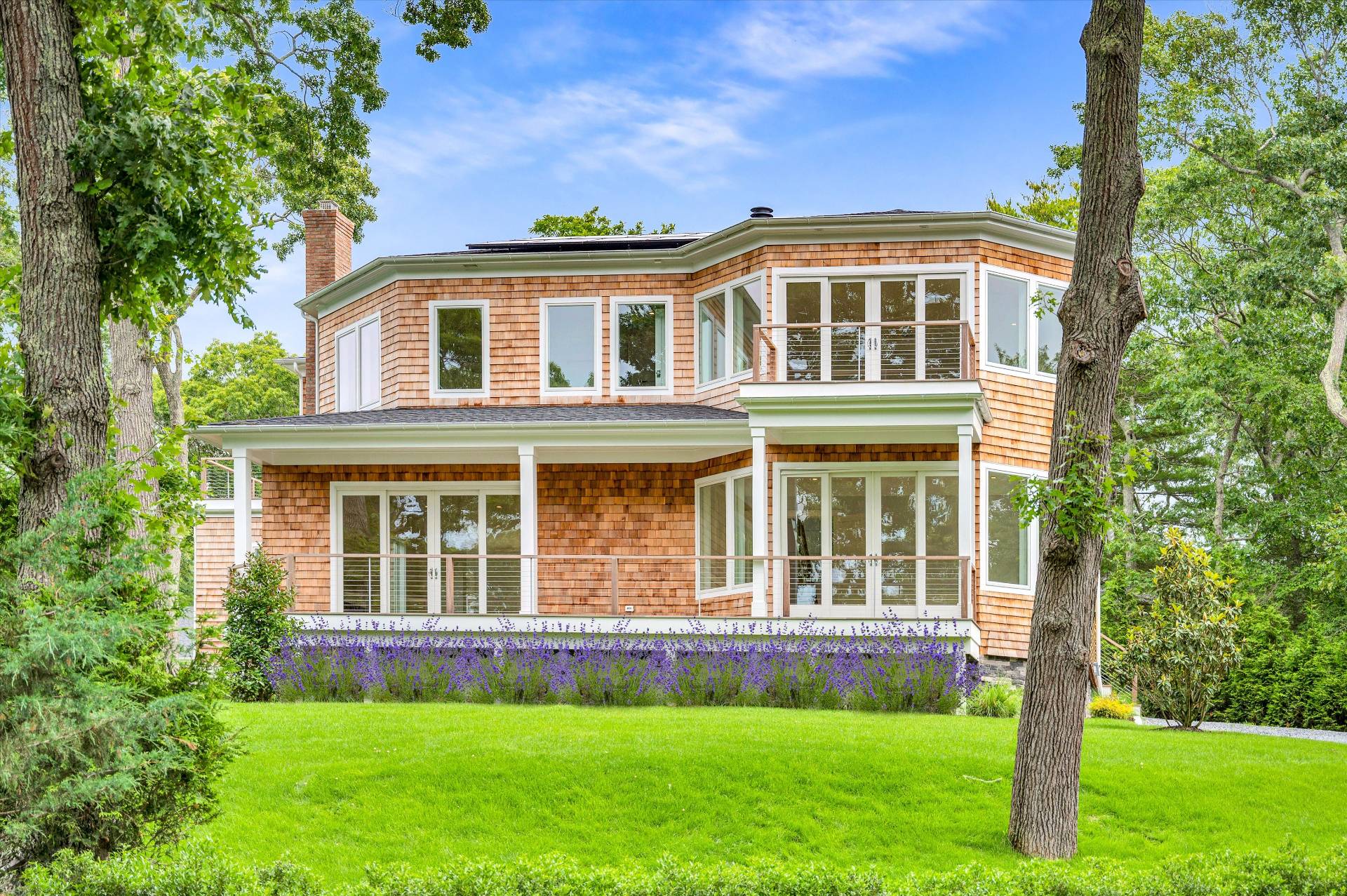 138 Big Fresh Pond Road Southampton, NY 11968 - Photo 6 of 43 a front view of a house with a yard