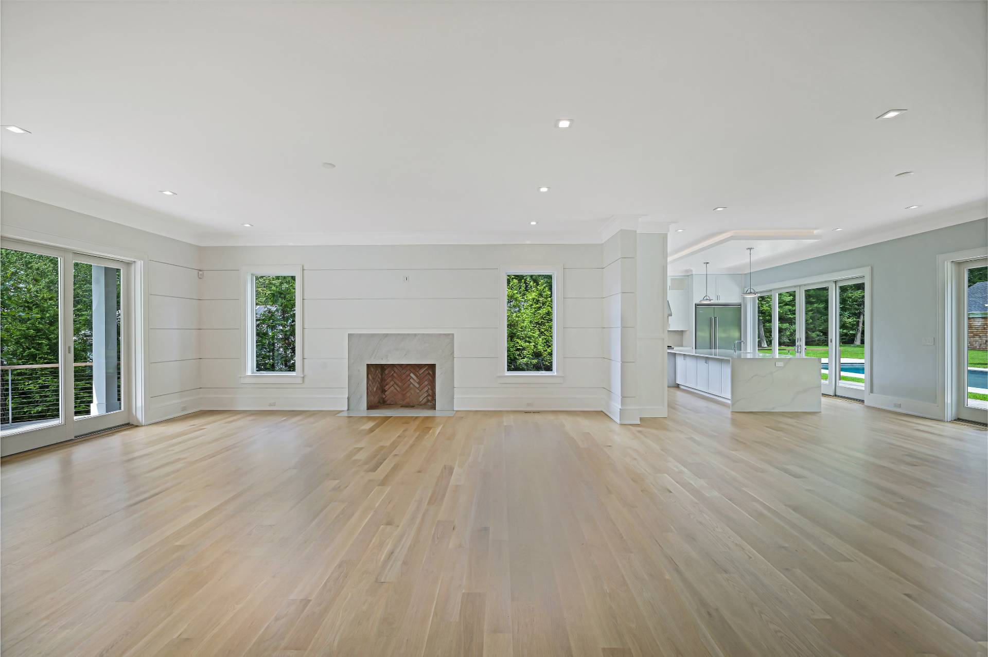 138 Big Fresh Pond Road Southampton, NY 11968 - Photo 10 of 43 a view of empty room with wooden floor and fireplace