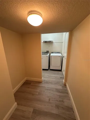 a room with a wooden floor and white walls