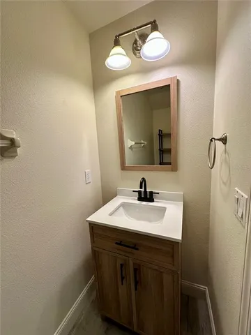 a bathroom with a sink vanity and a mirror