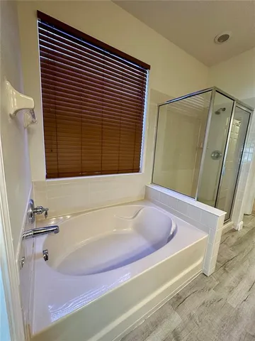 a bathroom with a bathtub and a shower