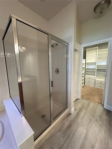 a bathroom with a glass door shower