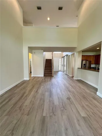 a empty room with wooden floor and furniture