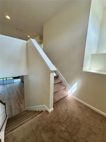 a view of an empty room with stairs