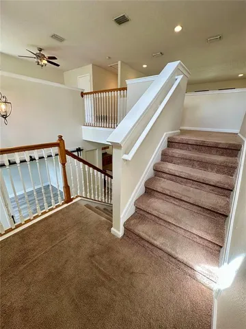 a view of staircase with lots of frames on wall