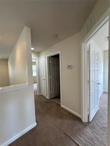 a view of hallway with bathroom