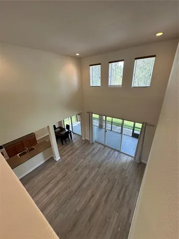 a view of an empty room with a fireplace and large windows