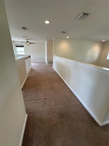 a view of an empty room with windows