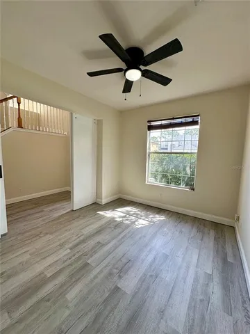 wooden floor in an empty room with a window