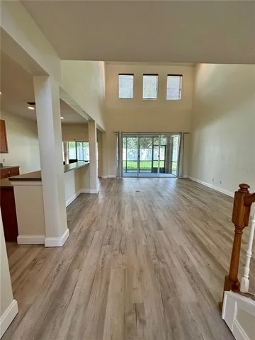 a view of empty room with wooden floor