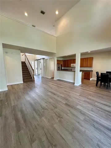 a view of a livingroom with wooden floor and furniture