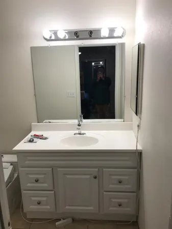 a bathroom with a sink and a mirror