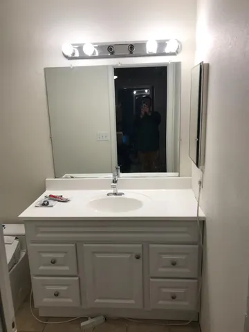 a bathroom with a sink and a mirror