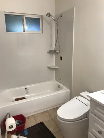 a bathroom with a sink a toilet and bathtub