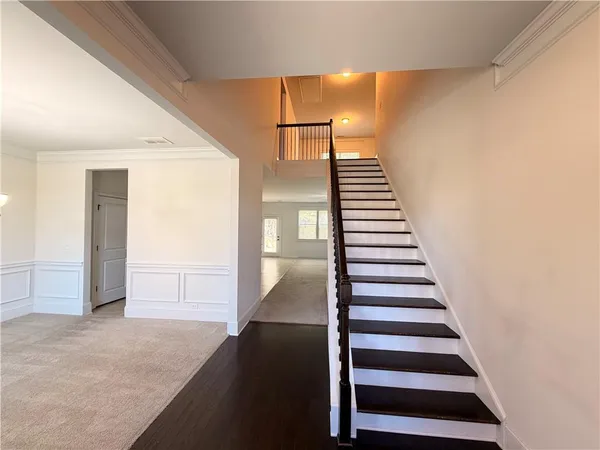 a view of entryway and hall with wooden floor