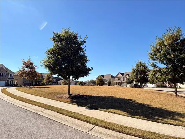 a view of an empty room with a kitchen and a fireplace