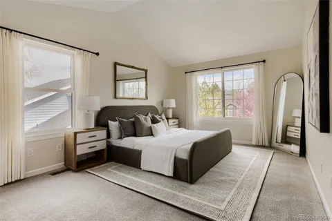 a bedroom with a bed and a large window