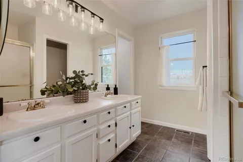 a bathroom with a double vanity sink and mirror