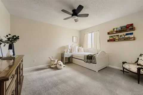 a bedroom with furniture and a ceiling fan