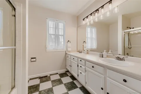 a bathroom with a double vanity sink mirror and double