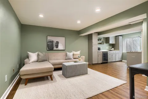 a living room with furniture and wooden floor