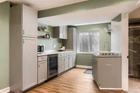 a kitchen with a sink stove and cabinets