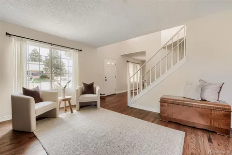 a living room with furniture and stairs