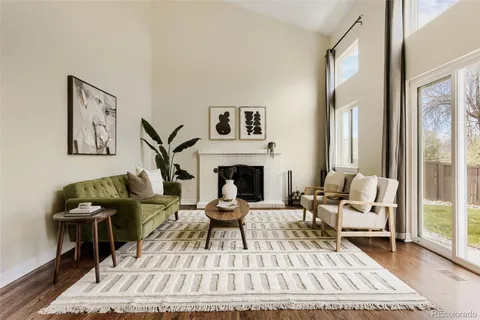 a living room with furniture a rug and a fireplace