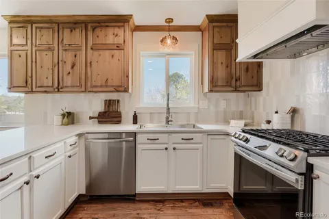 a kitchen with cabinets appliances and a sink
