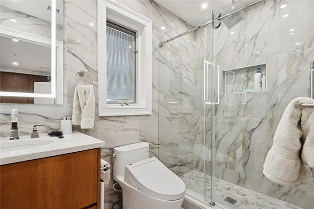 a bathroom with a sink toilet and shower