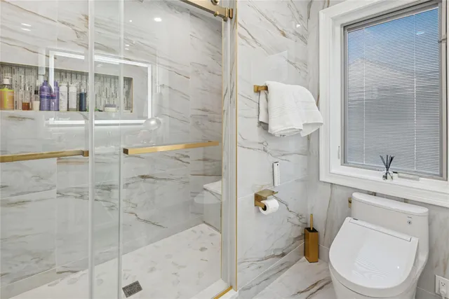 a bathroom with a toilet sink and shower