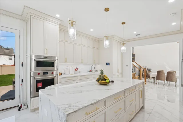 a kitchen with a sink a stove and chairs