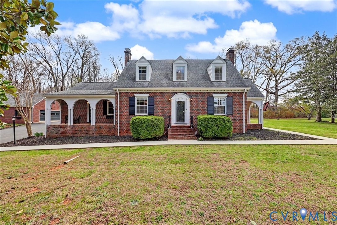 View of front facade featuring a chimney, a front