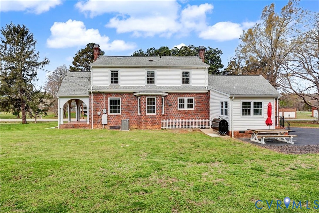 2800 Nottoway Boulevard Victoria, VA 23974 - Photo 41 of 45 Rear view of house with a chimney, a lawn, and a p