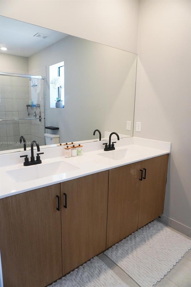 11942 Southwest 243rd Street Homestead, FL 33032 - Photo 18 of 50 a room with a sink and a mirror