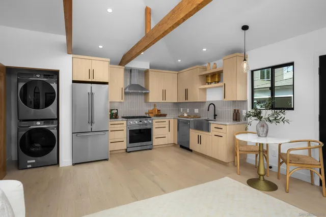 a kitchen with refrigerator a stove a sink and a stove