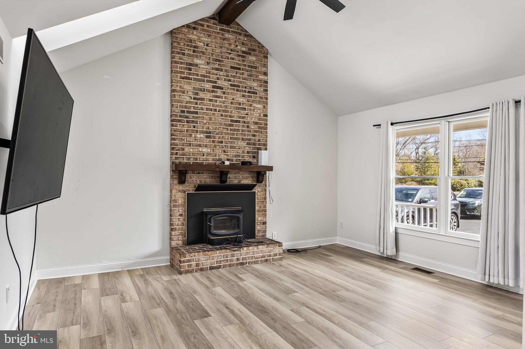 14 Taunton Road Medford, NJ 08055 - Photo 27 of 47 a view of an empty room with wooden floor fireplace and a window